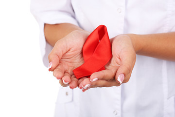 Canvas Print - Woman with aids awareness red ribbon in hands isolated on white