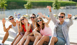 © Syda Productions - group of laughing friends sitting on city square