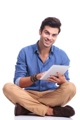 Poster - seated casual man working on his tablet pad computer