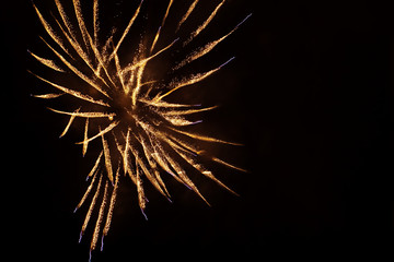 Golden orange fireworks on dark background