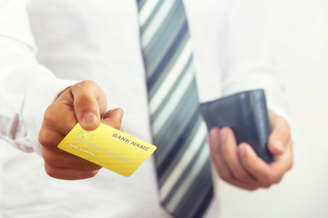 Businessman holding bank card.