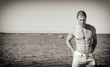 © M-Production - Muscular attractive man posing near the sea.