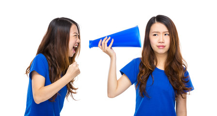 Woman yell to other with megaphone