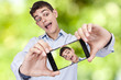 © carballo - Young boy with phone becoming a self-portrait