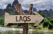 Vang Vieng wooden sign with a forest background