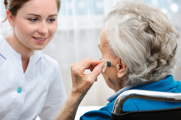 Wall Mural - Senior woman with a hearing aid