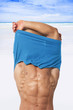 © Eskymaks - Sexy man undressing on beach.