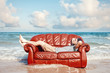 © Alex from the Rock - man resting in leather couch on the beach