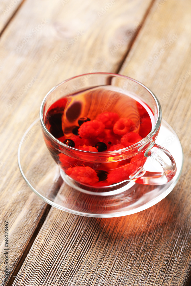 Fruit red tea with wild berries in glass cup,