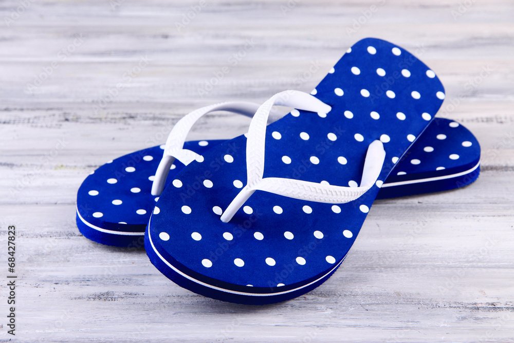 Color flip-flops on wooden background