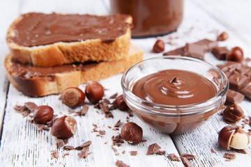 Canvas Print - Sweet chocolate cream in bowl on table close-up