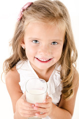 Poster - Smiling little girl drinking milk isolated on a white