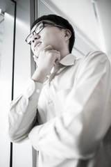 Wall Mural - Portrait of a businessman looking at the window