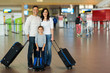 © michaeljung - family with suitcases at airport