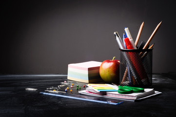 school supplies on the background of blackboard