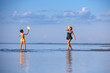 Young mother and son playing on the beach