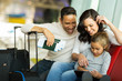 © michaeljung - little girl using tablet pc with parents at airport