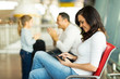 © michaeljung - young mother using tablet computer at airport