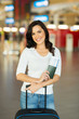 © michaeljung - young woman with luggage bag at airport
