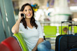 © michaeljung - traveller making a phone call at airport