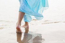 Woman Walking On The Beach