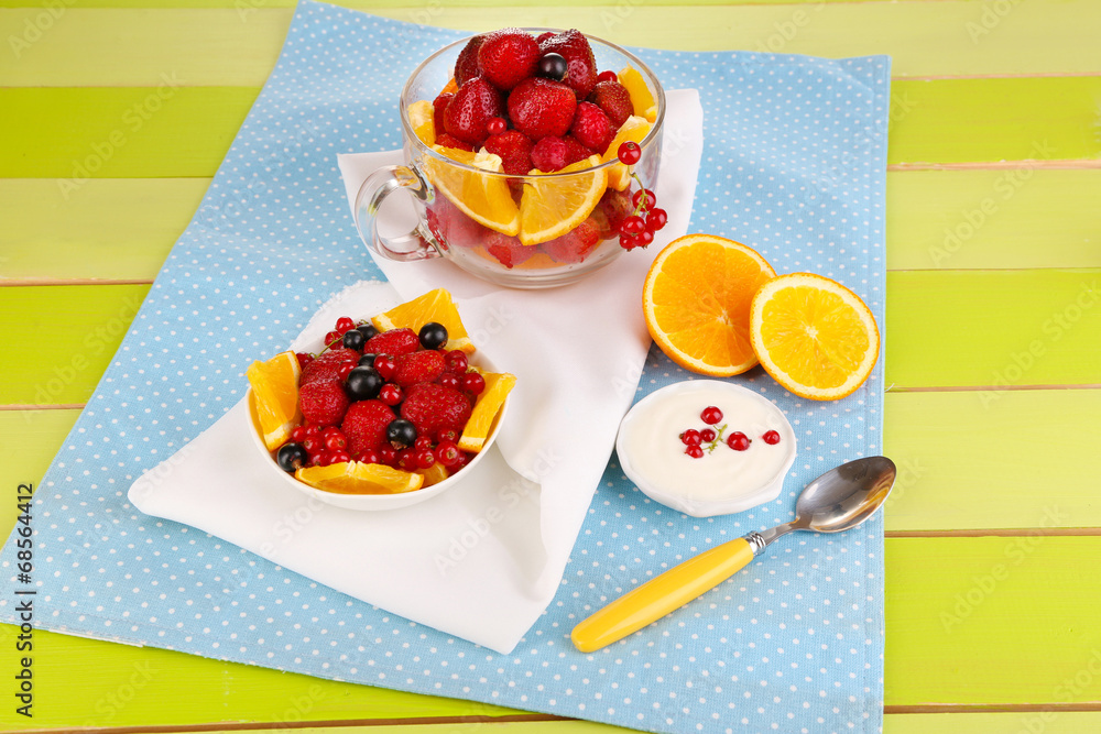 Useful fruit salad in glass cup and bowl