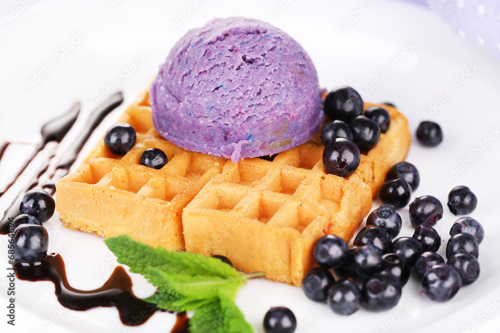 Tasty belgian waffles with ice cream on wooden table