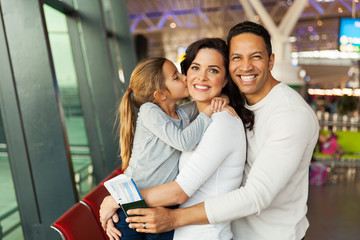 Wall Mural - little girl kissing her mother at airport