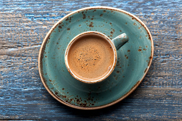 Coffee in cup on  blue wooden background