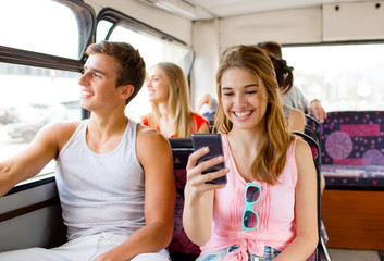 Wall Mural - smiling couple with smartphone making selfie