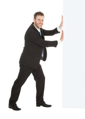 Businessman Pushing Something Over White Background