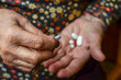 pills on hand of a senior person