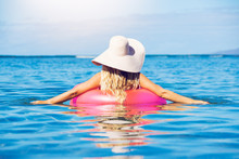 Woman Relaxing And Floating In The Ocean