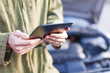 © Mikko Lemola - Mechanic using tablet computer wearing overalls under open hood