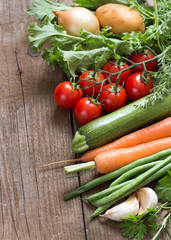 Organic vegetables and greens on a wooden table