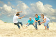© aletia2011 - Family playing football on a beach