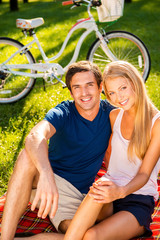 Canvas Print - Couple relaxing in park.