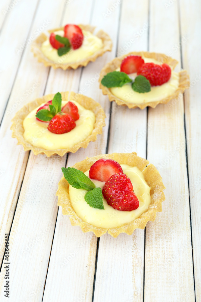 Tasty tartlets with strawberries on table close-up