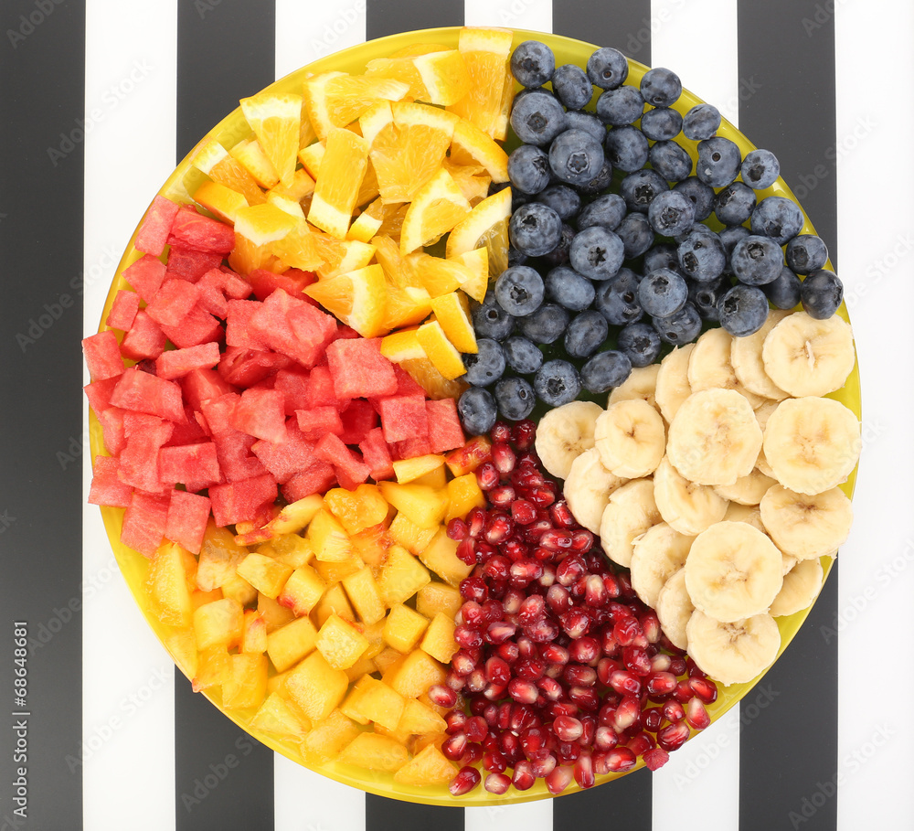 Sliced fruits on plate on table