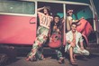 © Nejron Photo - Multi-ethnic hippie friends with guitar on a road trip