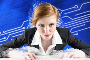 Poster - Composite image of redhead businesswoman sitting at desk typing