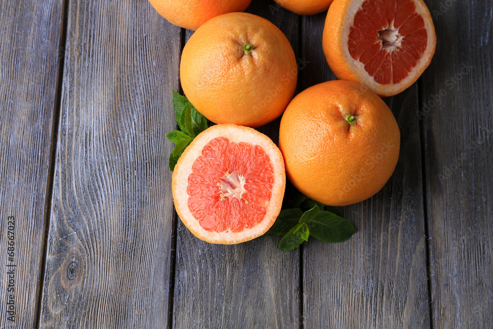 Ripe grapefruits on wooden background