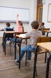 © WavebreakmediaMicro - Disabled pupil writing at desk in classroom