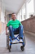 © WavebreakmediaMicro - Cute disabled pupil smiling at camera in hall
