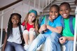 © WavebreakmediaMicro - Cute pupils smiling at camera on the stairs