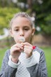 © WavebreakmediaMicro - Cute little girl blowing dandelion