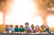 © WavebreakmediaMicro - Composite image of cute pupils smiling at camera with teacher