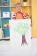 © WavebreakMediaMicro - Cute little boy showing his painting in classroom