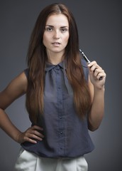 Elegant, beautiful woman smoking e-cigarette