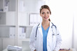 © lenets_tan - Portrait of young woman doctor with white coat standing in